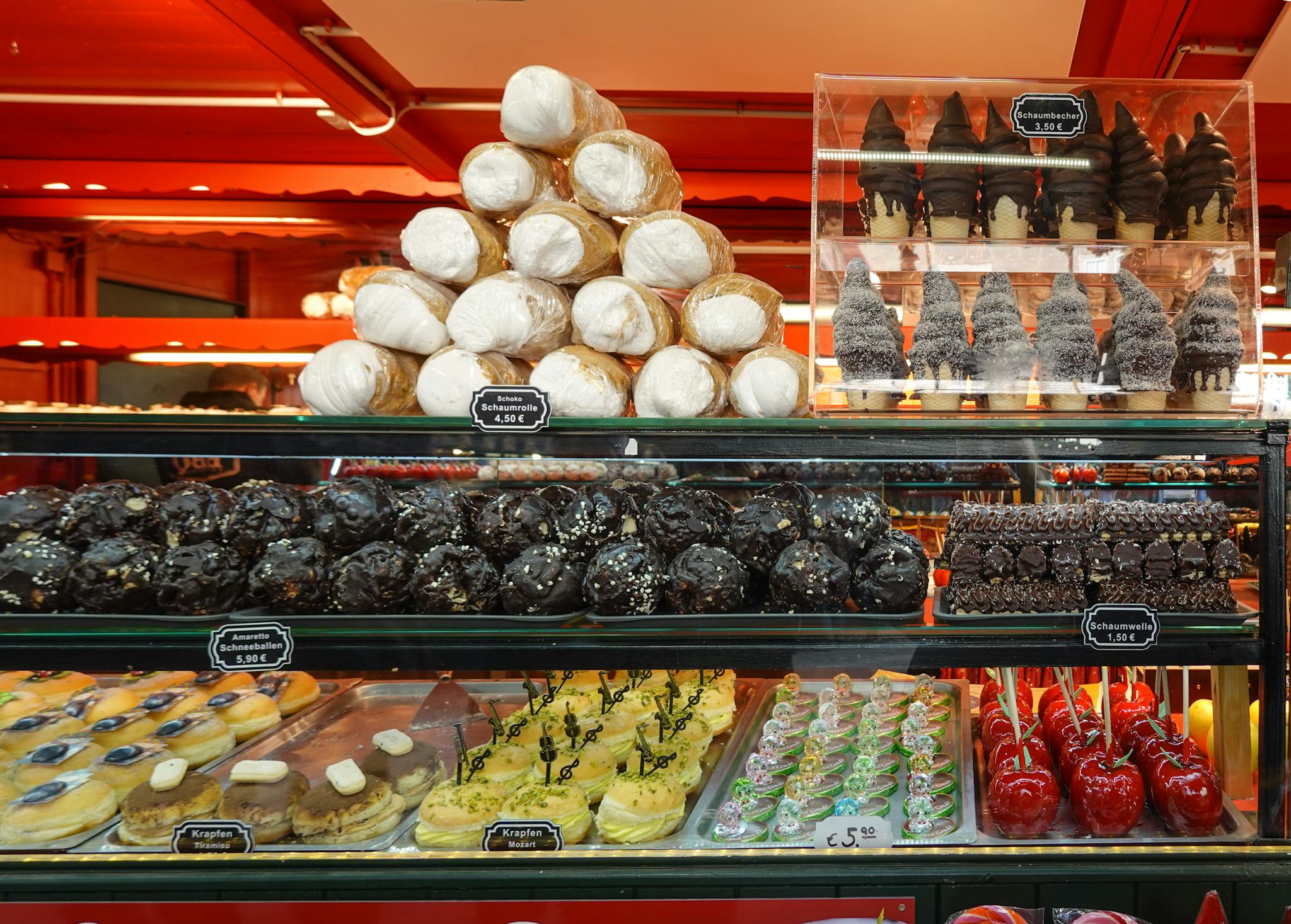 Delicious assortment of pastries and sweets on display in a vibrant bakery. Perfect temptation for dessert lovers.