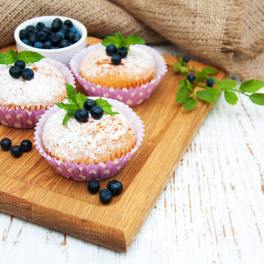 Muffins with blueberry on a old wooden background